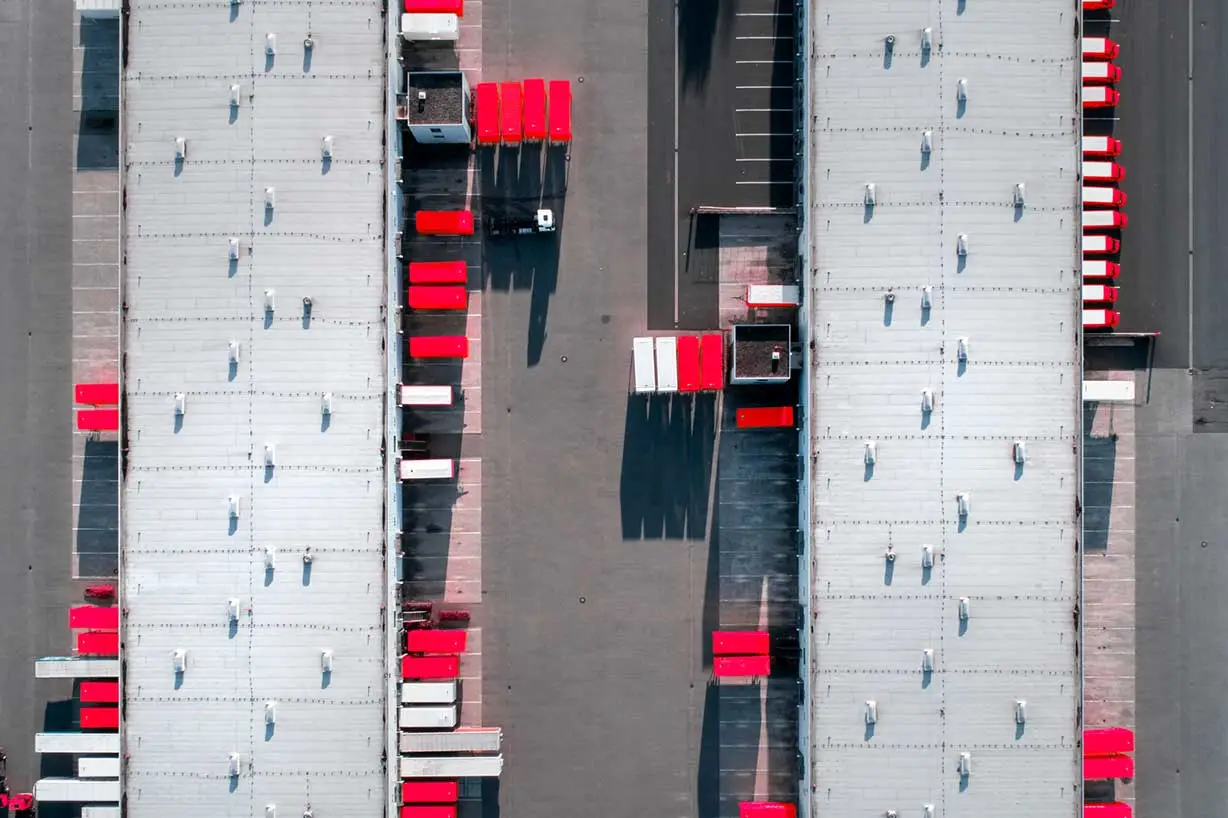 A well-run warehouse with trucks coming in and out to deliver and pickup goods